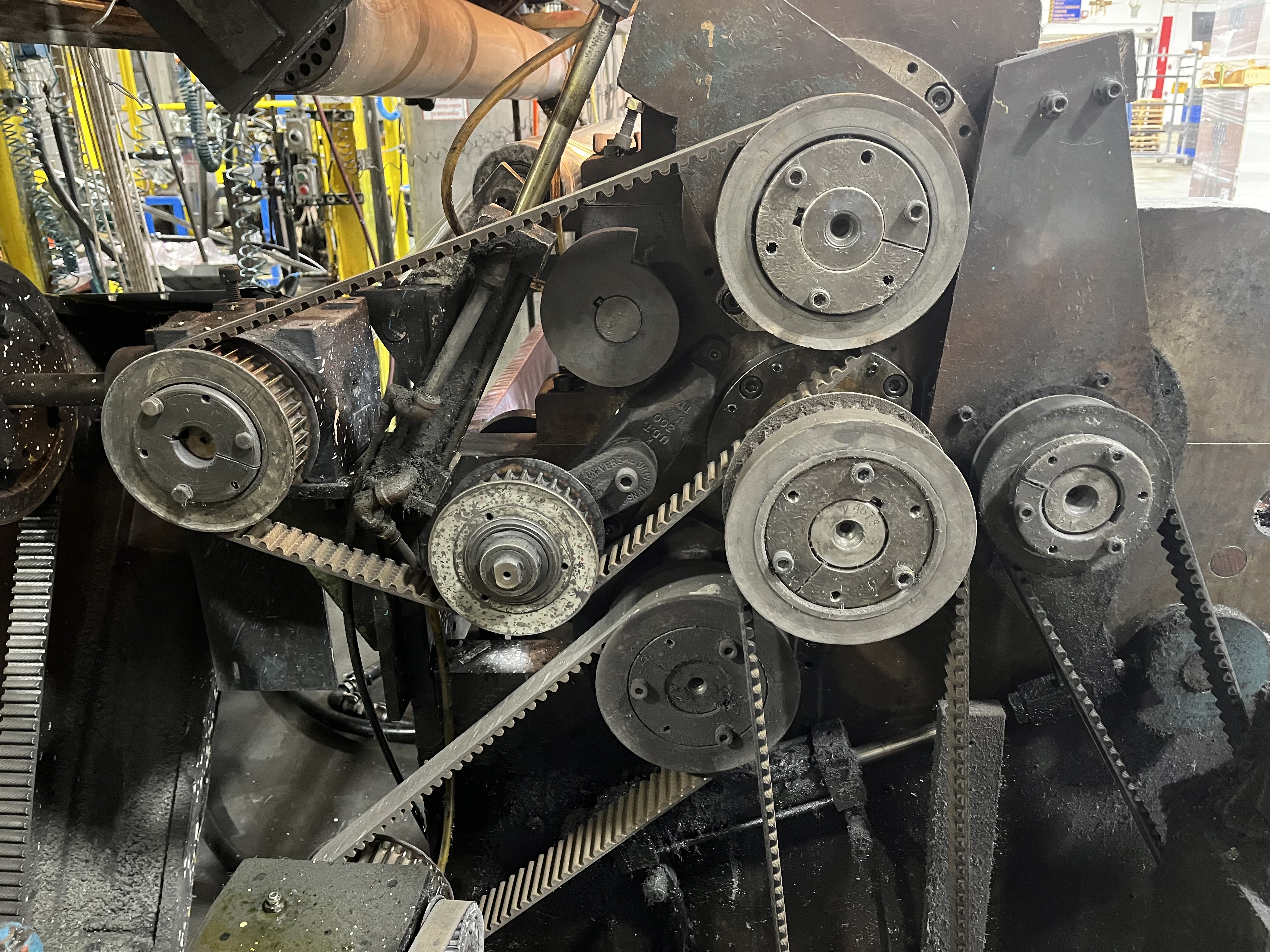 Legacy Link-Belt PIV mechanical variable speed drive units on a production line, showing worn and dusty belts and gears at Apex Industrial Automation.