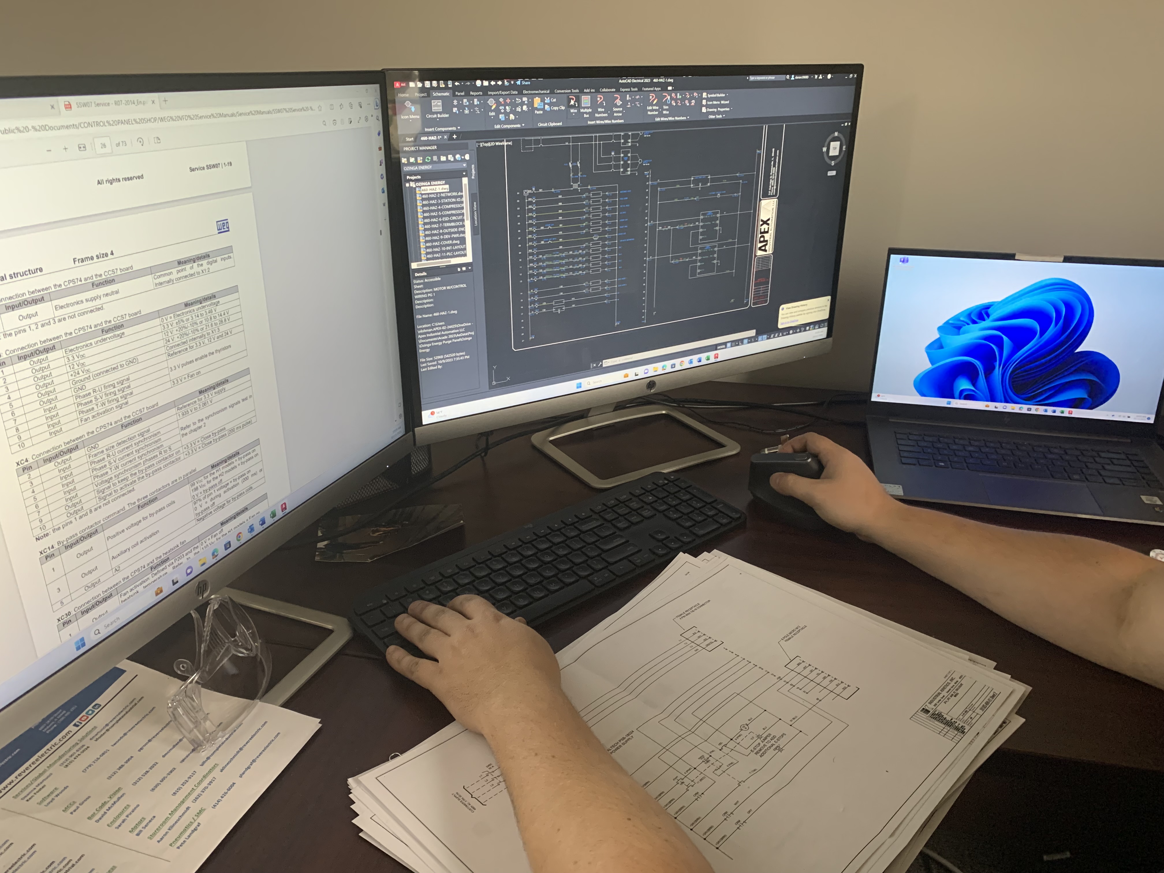 Apex Industrial Automation control panel designer using AutoCAD on two monitors.