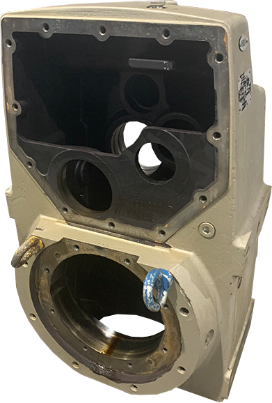 Large disassembled gearbox with tan housing and dark grey unpainted parts at Apex Industrial Automation.